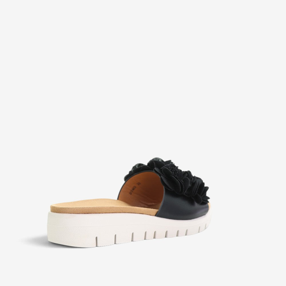 Black slip-on shoes from CC Resorts Domo collection, featuring a sleek design and comfortable fit.
