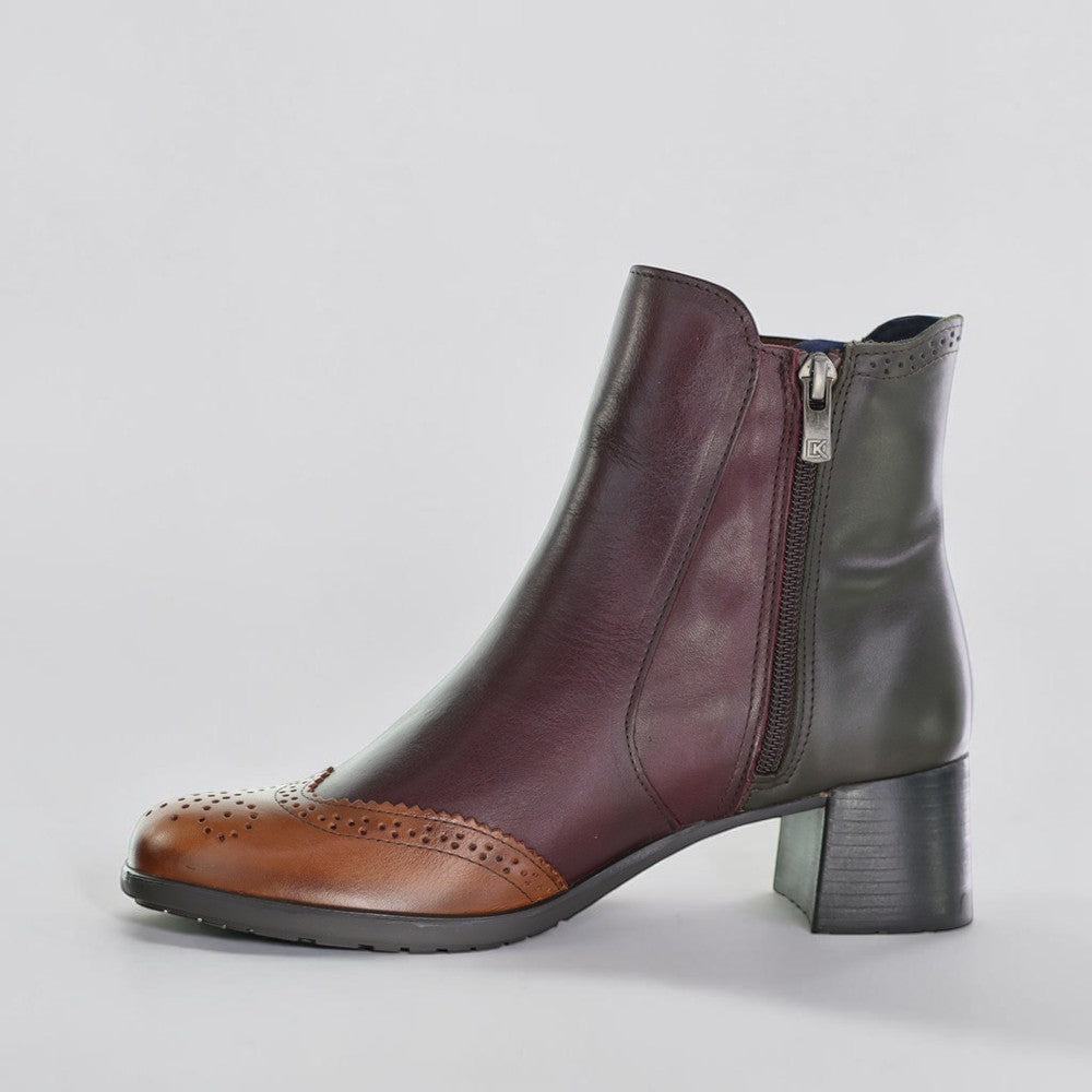 Dorking Ikia Bosque leather ankle boots with lace-up design and wooden heel, featuring a stylish brown finish and detailed stitching.