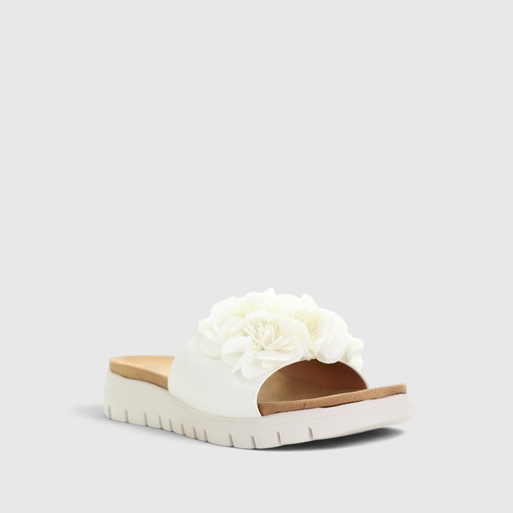 White slip-on shoes from CC Resorts with a sleek design, featured in a close-up showing the comfortable upper material.