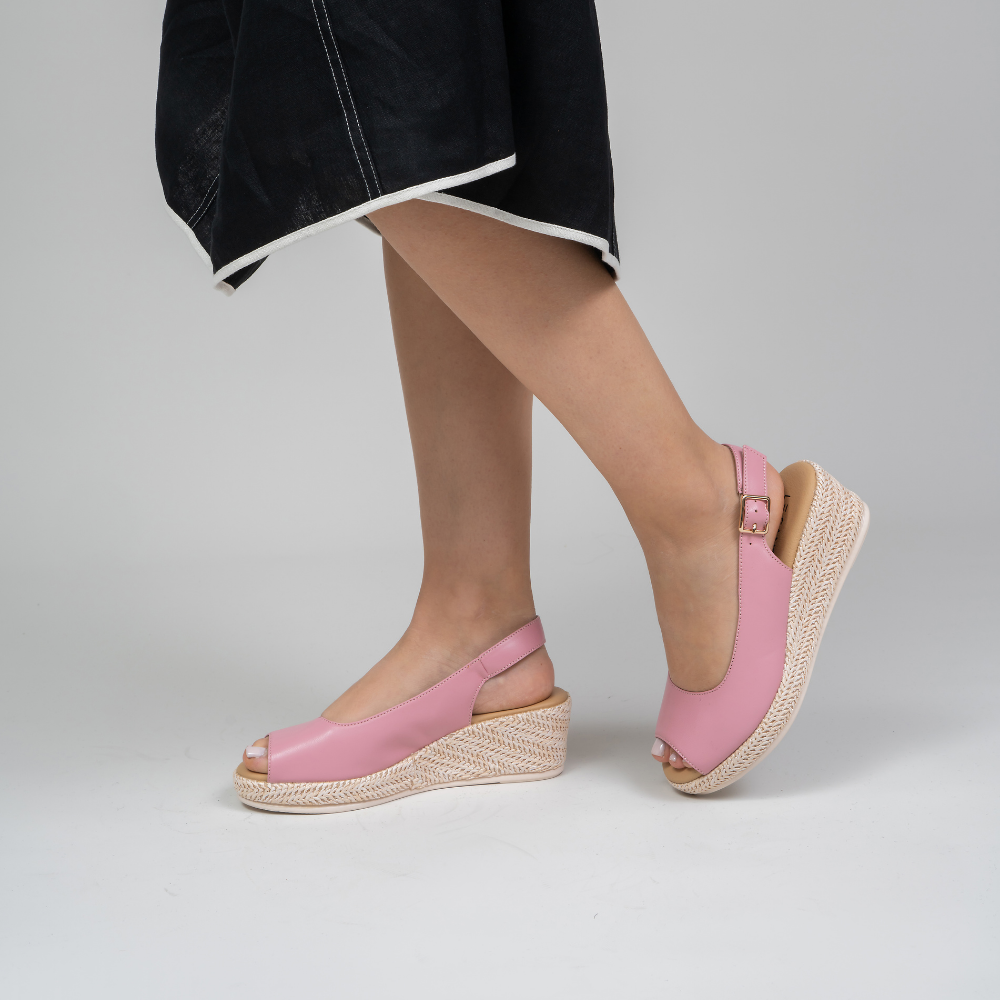 Le Sansa Petunia baby pink sandals with soft straps and small bow detail, designed for comfortable, stylish little feet.