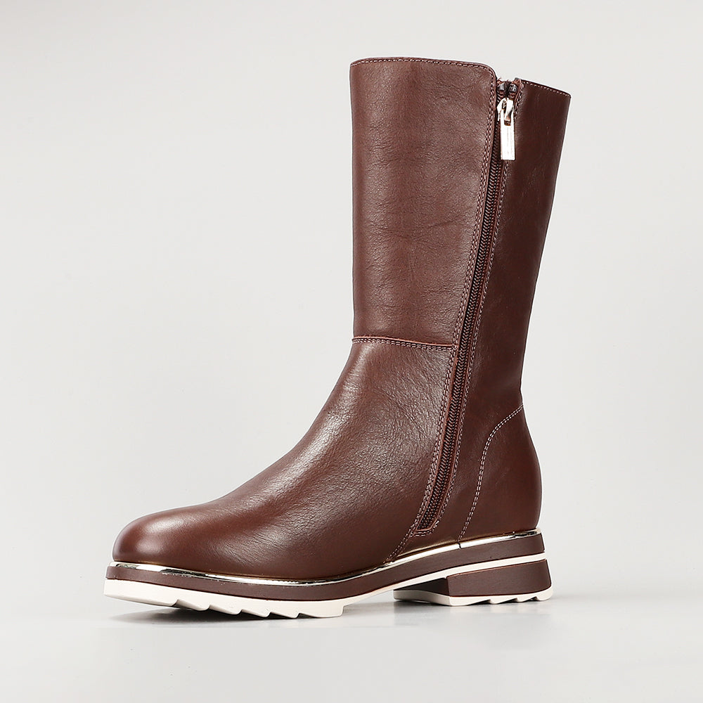 Le Sansa Buffy chocolate boots with lace-up design and chunky sole, displayed on a neutral background.