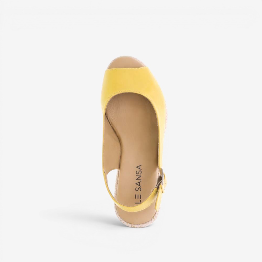 Le Sansa Petunia Mustard sandals with open-toe design, featuring stylish straps and a comfortable flat sole.
