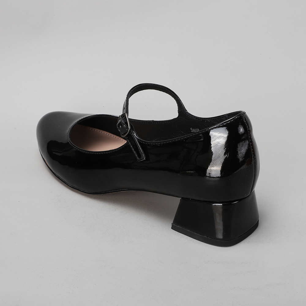 Naked Arches black patent sandals with sleek strap design and flat sole, stylish footwear for casual or dressy occasions.