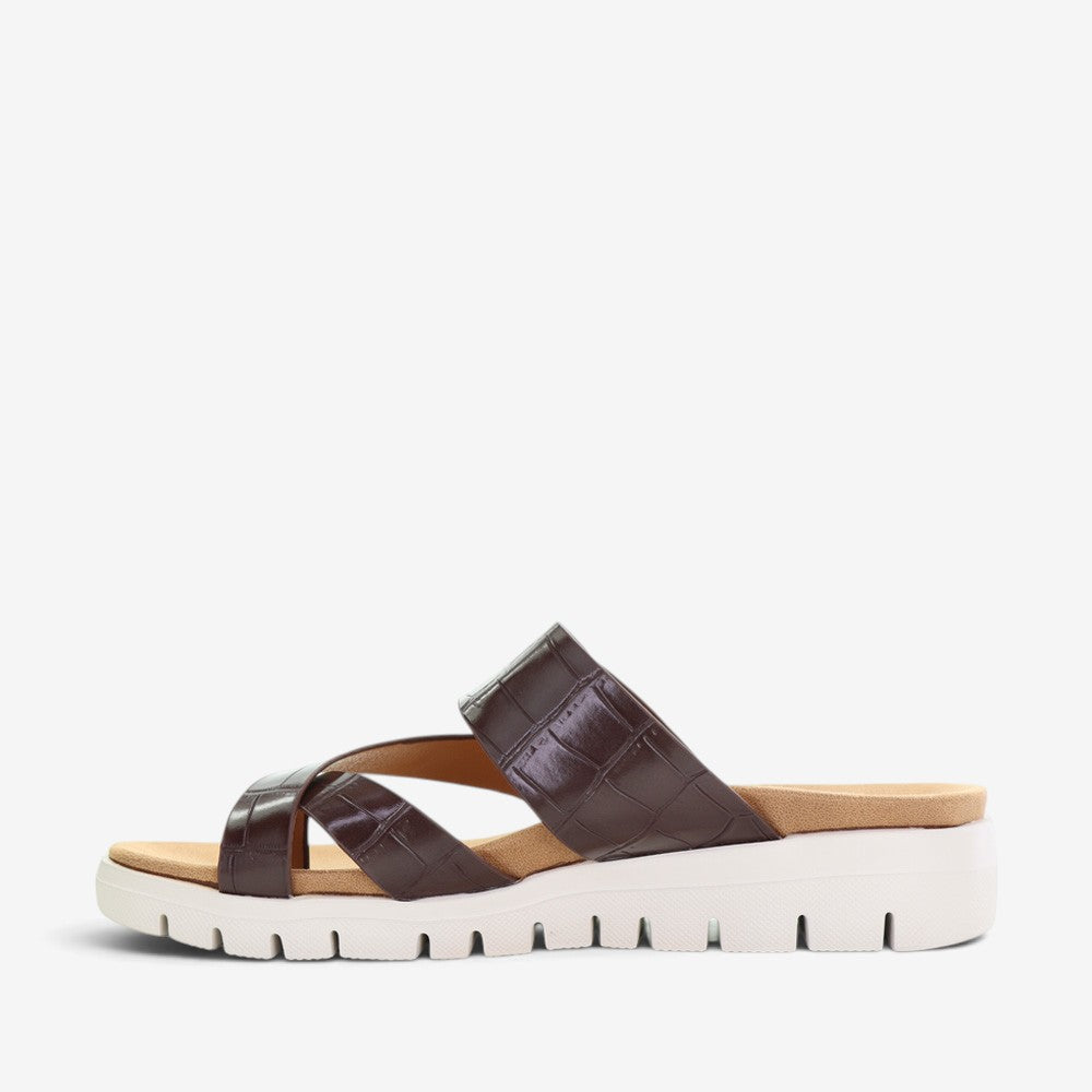 CC Resorts Domino Chocolate Crocs slip-ons with a sleek chocolate brown design and comfortable casual style.