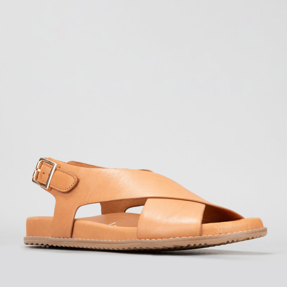 Naked Arches Zigilia Tan sandals with adjustable straps and cushioned footbed, featuring tan leather straps and a sturdy sole.