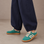 Le Sansa Juno sneakers in pine green and taupe with a stylish, casual design and lace-up closure.