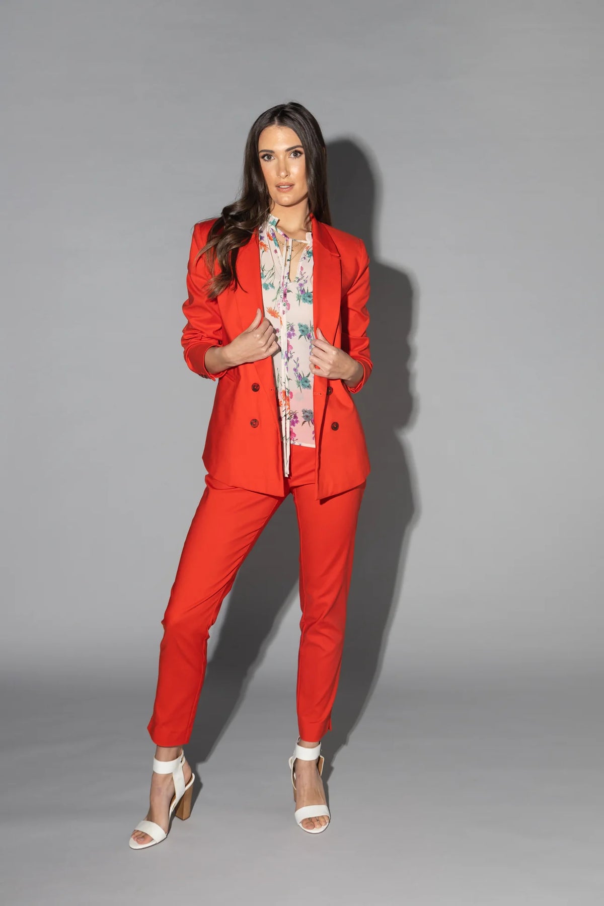 Drama The Label Flutter Blouse in Summer Garden print, lightweight top with ruffled details and sleeveless design.