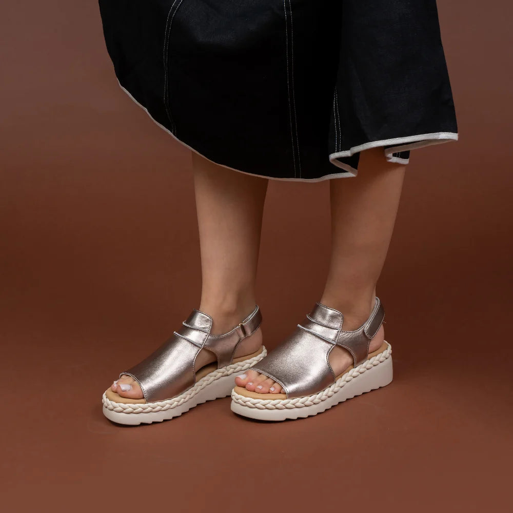 Le Sansa Emmeline Gold sandals with thin straps and a sleek design, perfect for stylish summer wear.