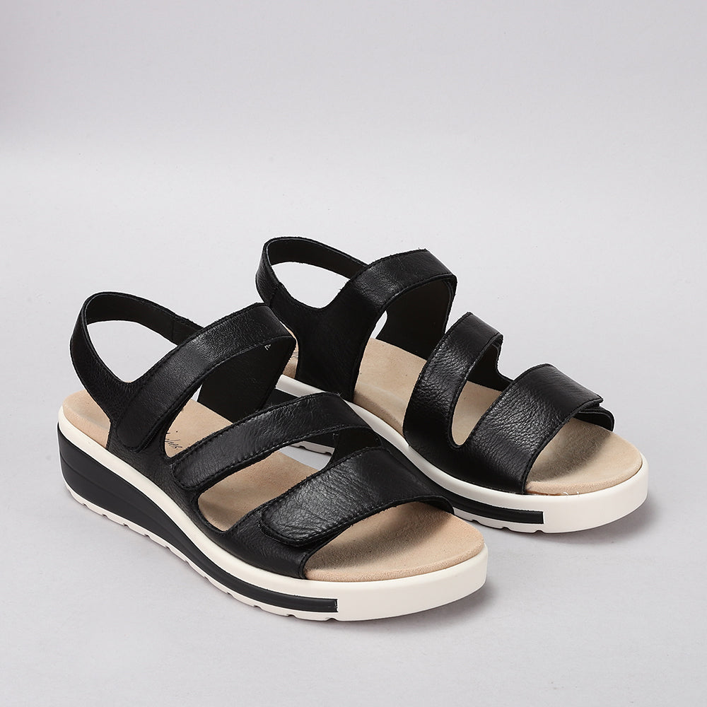 NAKED ARCHES Holiday Black sandals with sleek black straps and cushioned footbed for casual summer wear.