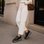 Le Sansa Skippa black sneakers with sleek design and white sole, displayed on a plain background.