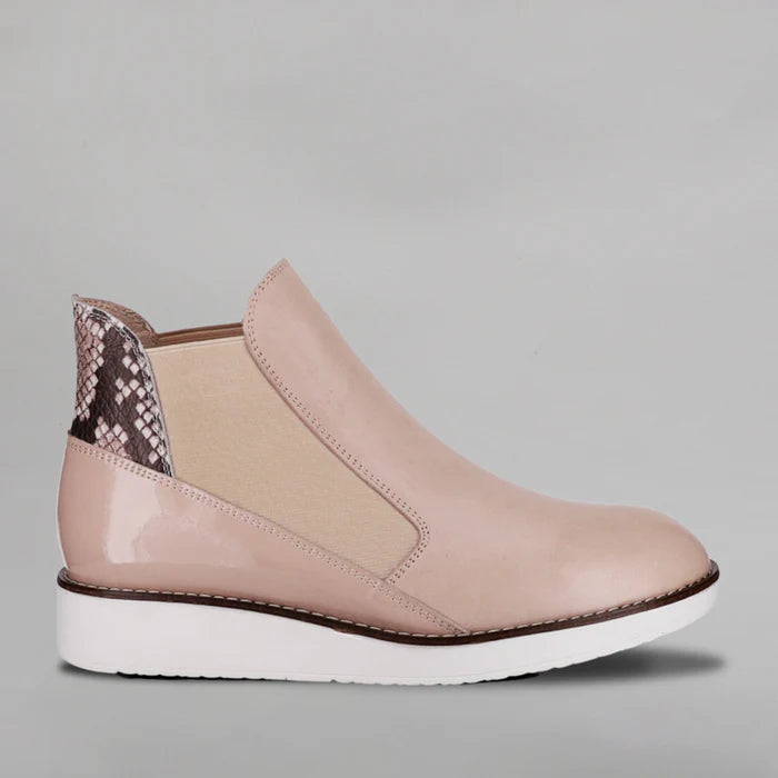 Le Sansa Rally Blush Rosegold boots with pointed toes and ankle height, featuring a sleek, shiny finish and stylish design.