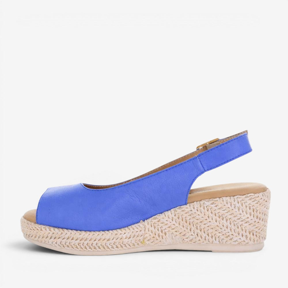 Le Sansa Petunia Royal Blue sandals with open toe design and ankle strap, showcasing stylish, comfortable footwear.