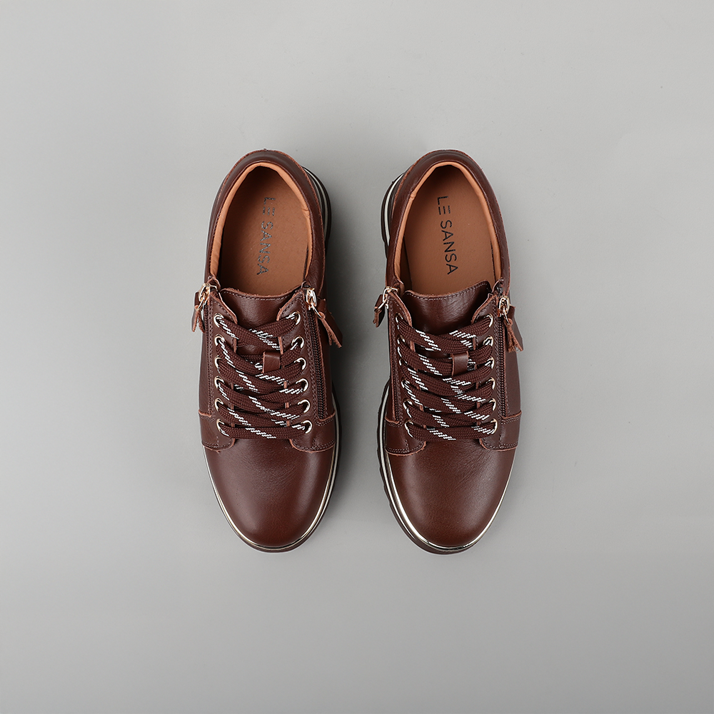 Le Sansa Skippa Chocolate sneakers with sleek design, brown suede finish, and comfortable rubber sole for casual wear.