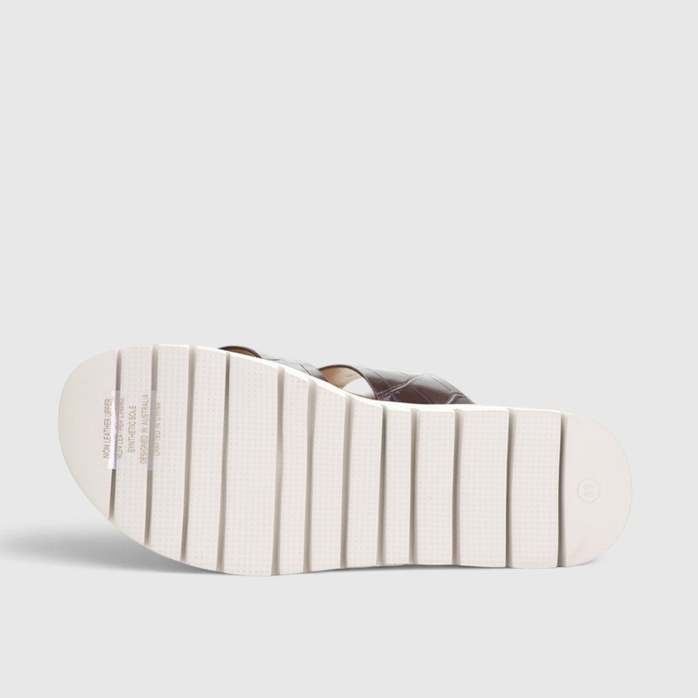 CC Resorts Domino Chocolate Crocs slip-ons featuring a sleek chocolate brown design with comfortable, casual footwear.