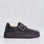Black Le Sansa Philia sneakers featuring a sleek design and comfortable fit, displayed on a white background.
