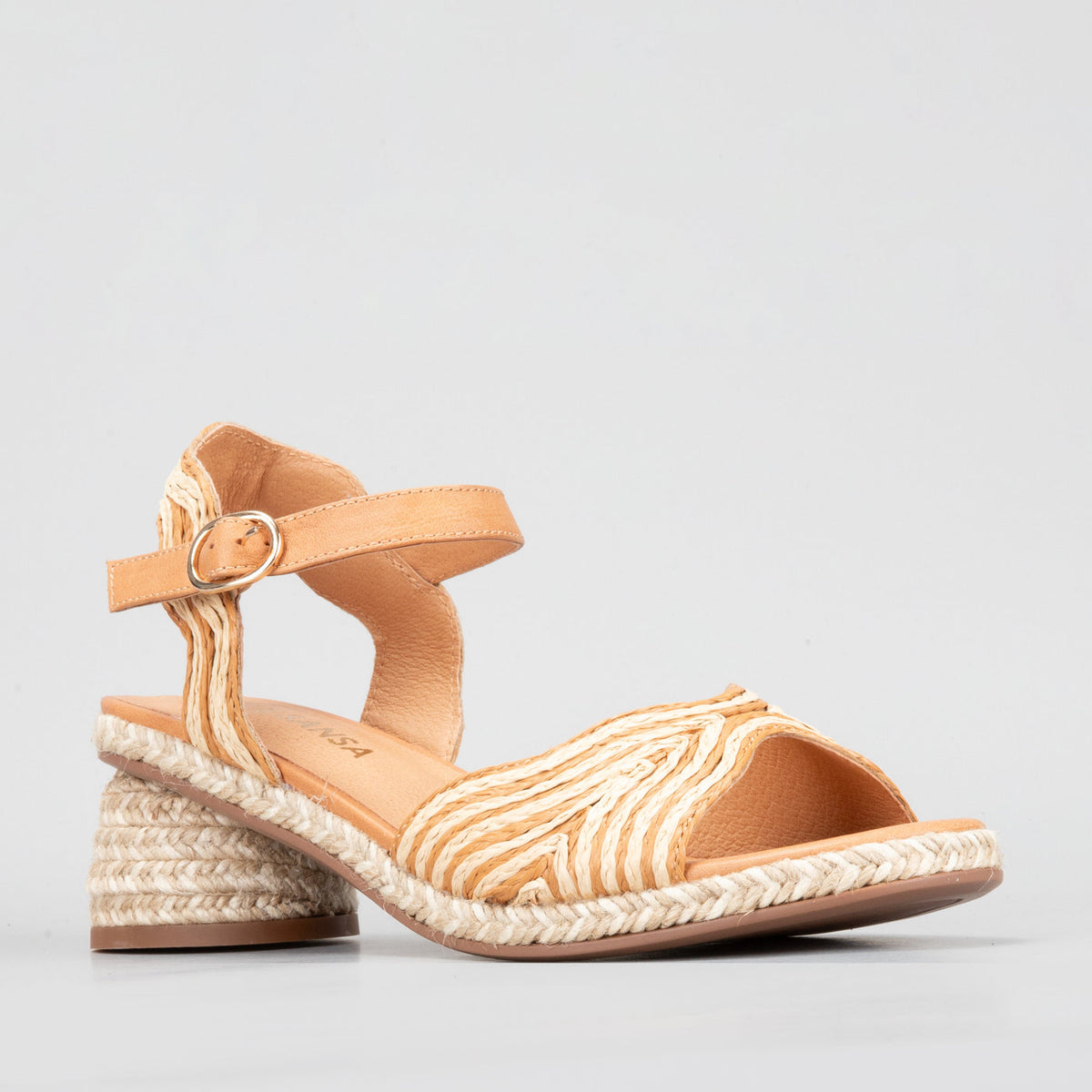 Le Sansa Alys tan and beige sandals with open toes and ankle straps, displayed on a neutral background.