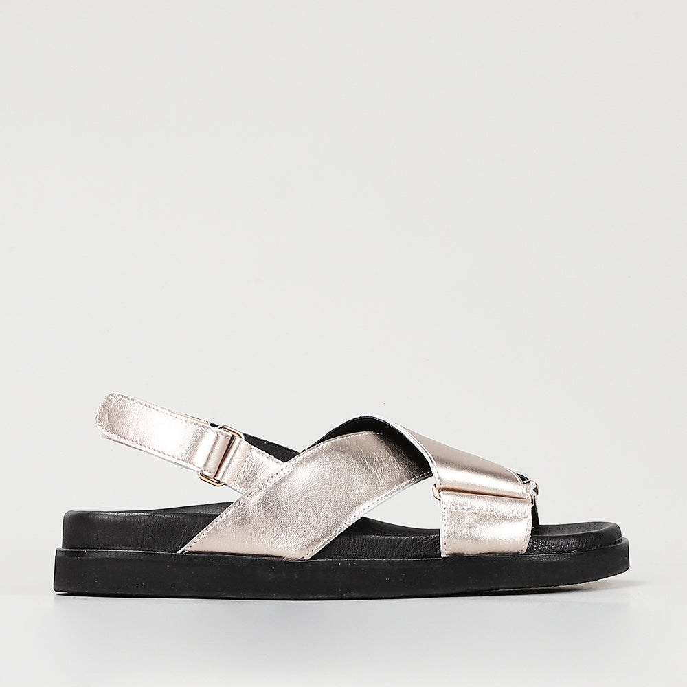 Naked Arches Marlo Champagne sandals with open toes and ankle straps, featuring a sleek champagne-colored design.