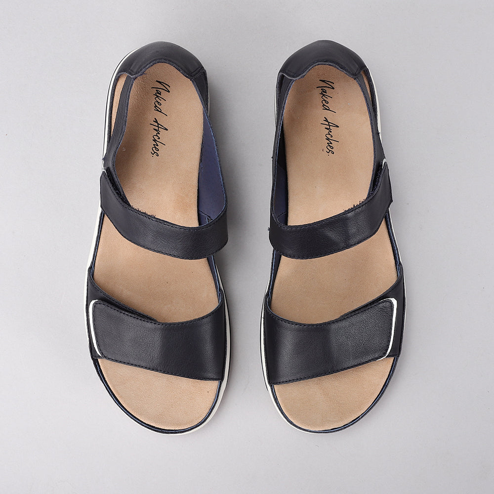 NAKED ARCHES Happy Navy sandals with navy straps and cushioned footbed, designed for comfortable casual wear.