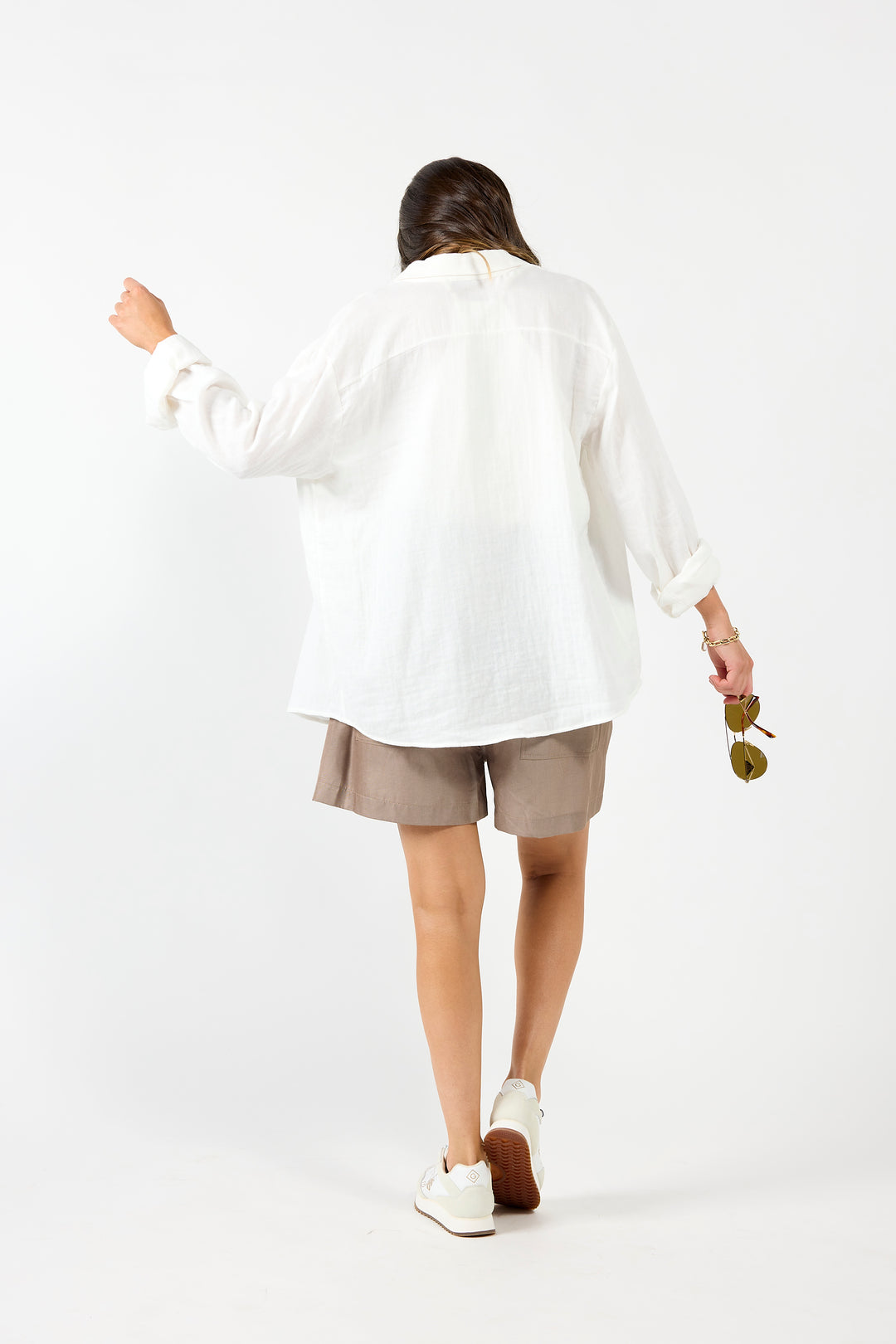 White drama The Label shirt featuring a classic, relaxed fit blouse with a collar and button-down front, displayed on a hanger.