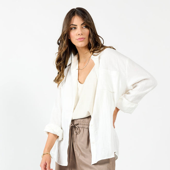 White Drama The Label The Shirt, a casual top with a relaxed fit, shown on a model with short sleeves and a classic collar.