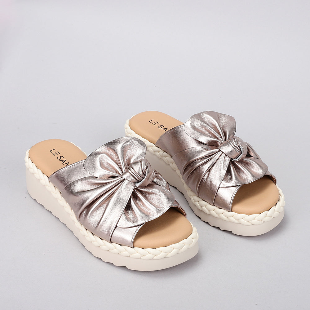 LE SANSA Eudore Champagne slip-ons featuring a sleek design and neutral champagne color, perfect for casual or semi-formal wear.