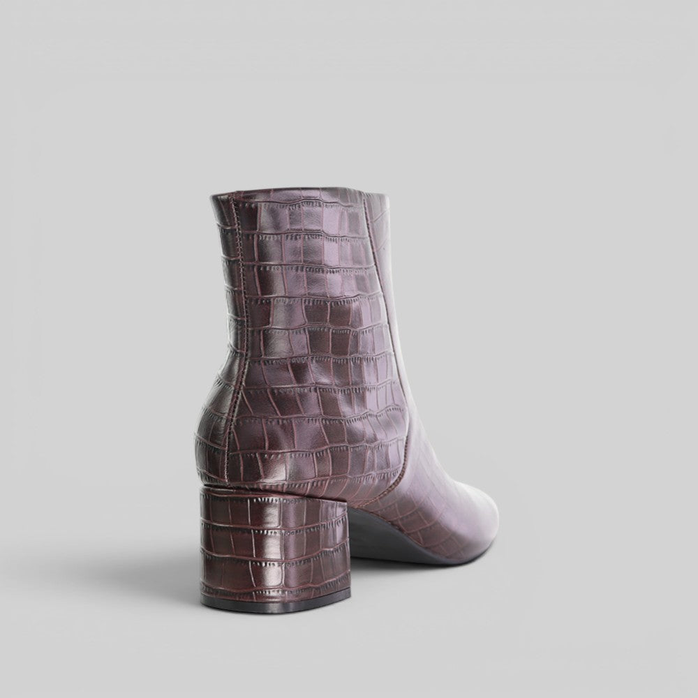 Le Sansa Rocket Chocolate Croc boots with textured crocodile pattern and slip-on style, featuring a chunky sole.