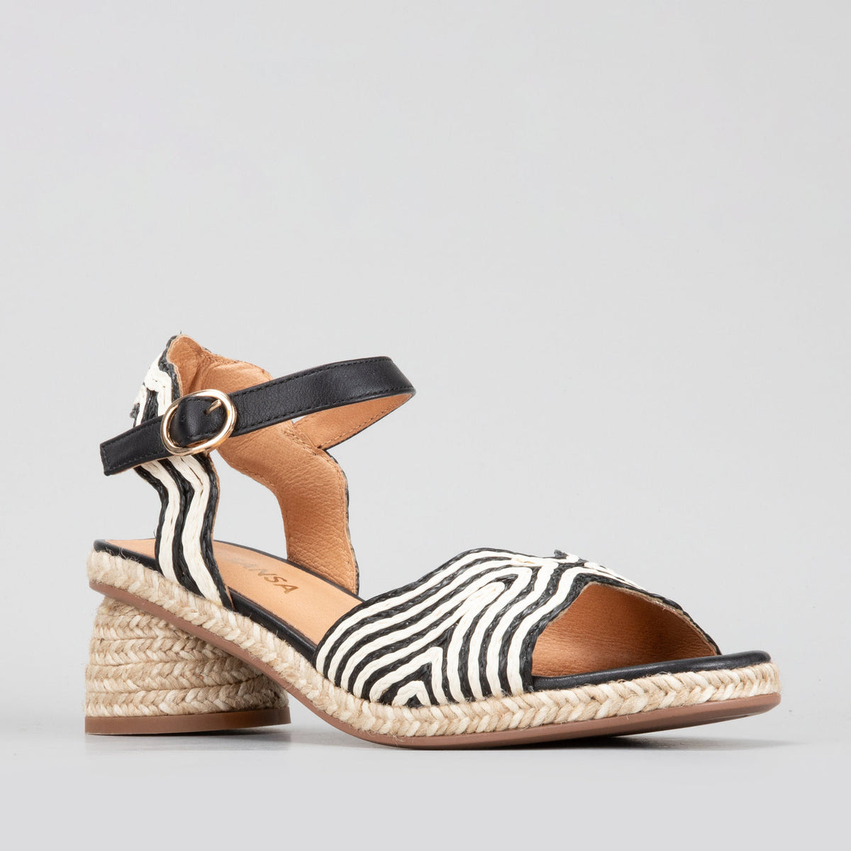 Le Sansa Alys black and white sandals with open toes and ankle straps, displayed on a neutral background.