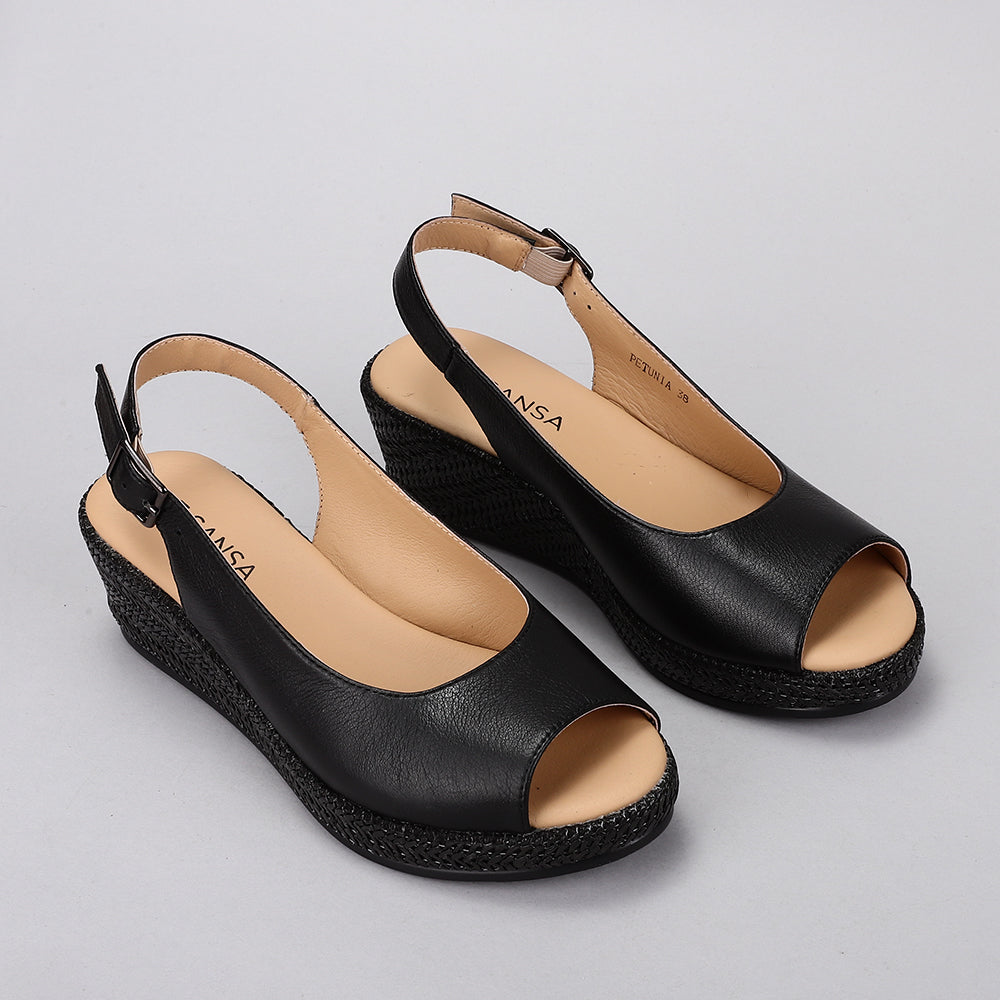 Black Le Sansa Sansa Petunia sandals with open toe design and ankle straps, stylish for casual summer wear.