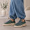 Le Sansa Palmer Olive sneakers featuring a stylish olive green design with white sole and breathable fabric.