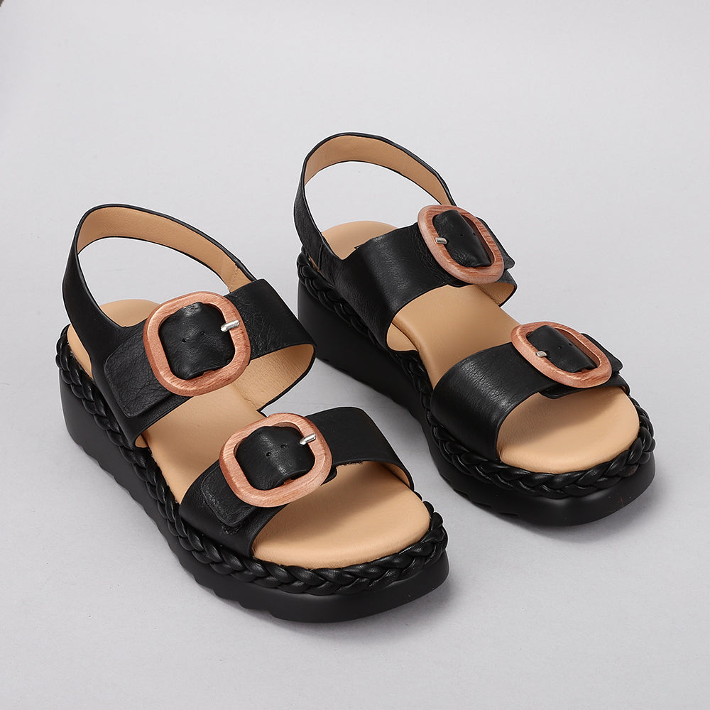 Black leather Sansa Emery sandals by Le Sansa featuring open toes and adjustable straps for a stylish, comfortable fit.