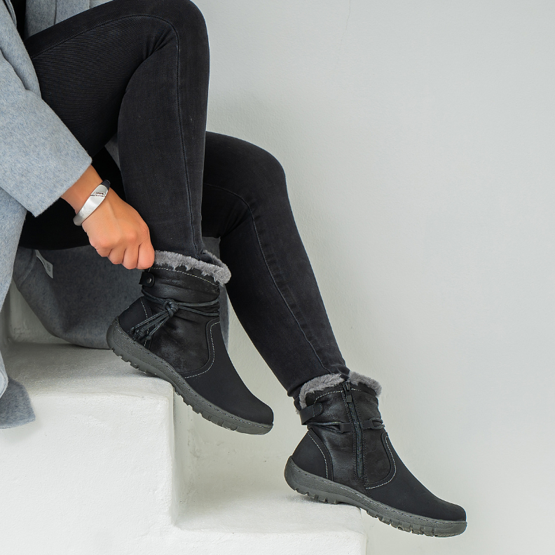 Black CC Resorts Gemma boots with lace-up design and chunky sole, styled with casual outfit on a neutral background.