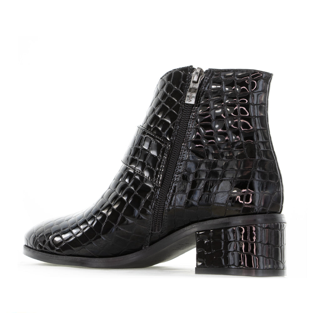 Black Le Sansa Andy boots with printed design, featuring a stylish ankle boot silhouette and textured sole.