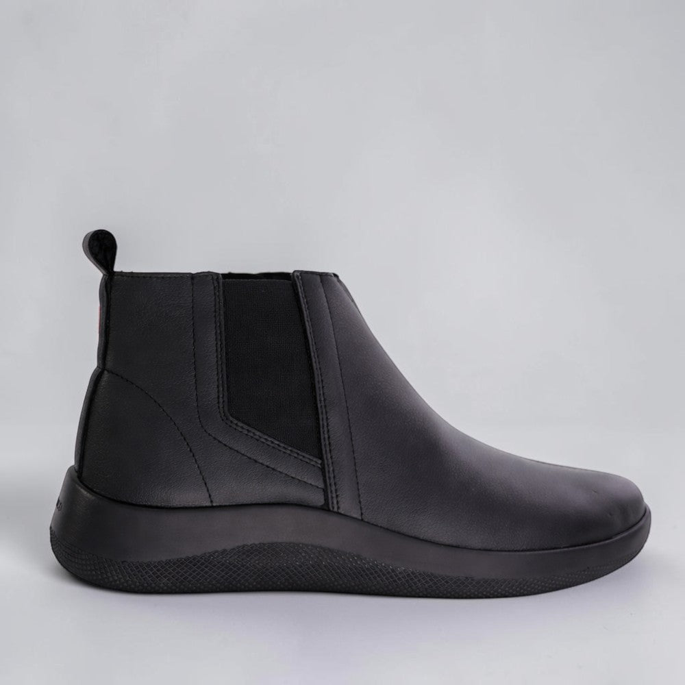 Arcopedico Rago black and grey boots with sleek leather design, featuring comfortable slip-on style and rounded toes.