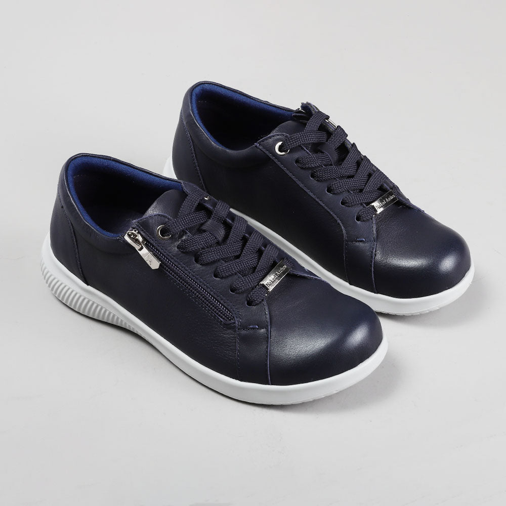 Pair of NAKED ARCHES AVI NAVY sneakers showing navy blue athletic sneakers with white soles and branding details.