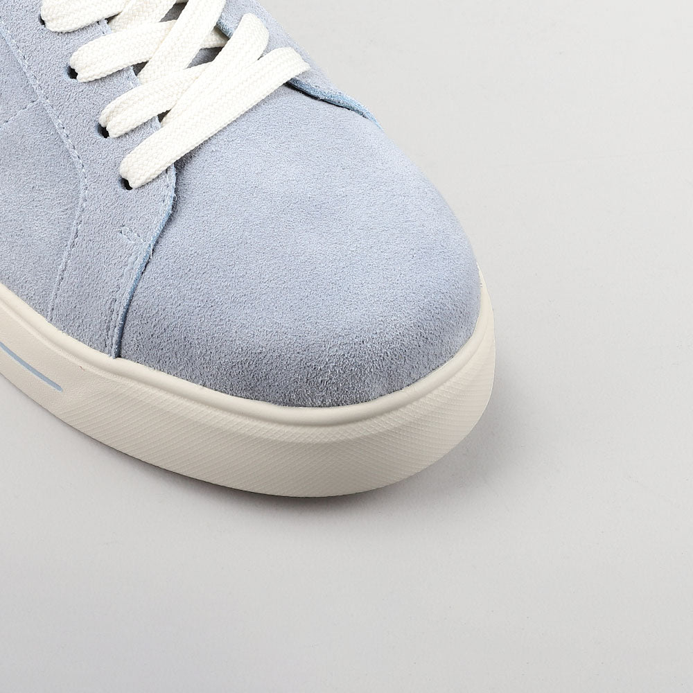 Close-up of Naked Arches Azealia denim sneakers showing blue denim material and stylish design details.