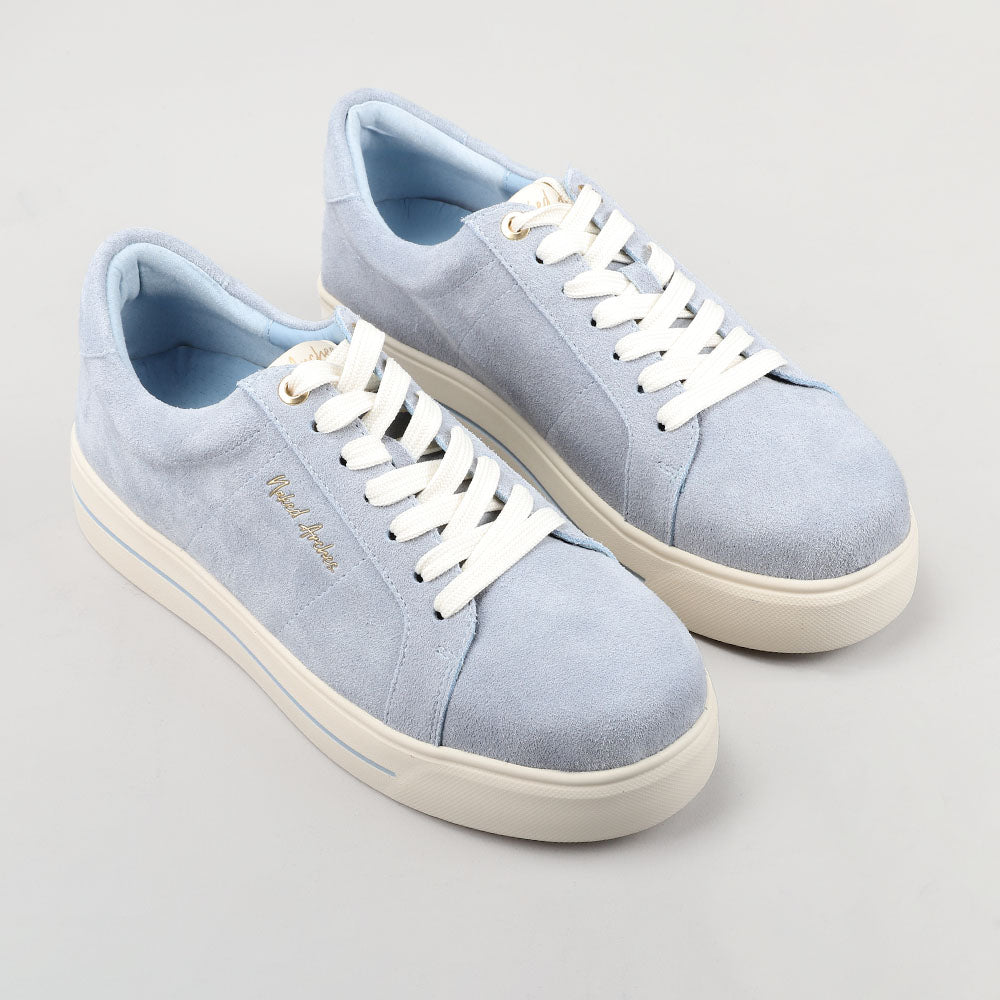 Naked Arches Azealia denim sneakers with suede details, white laces, and a casual slip-on design.
