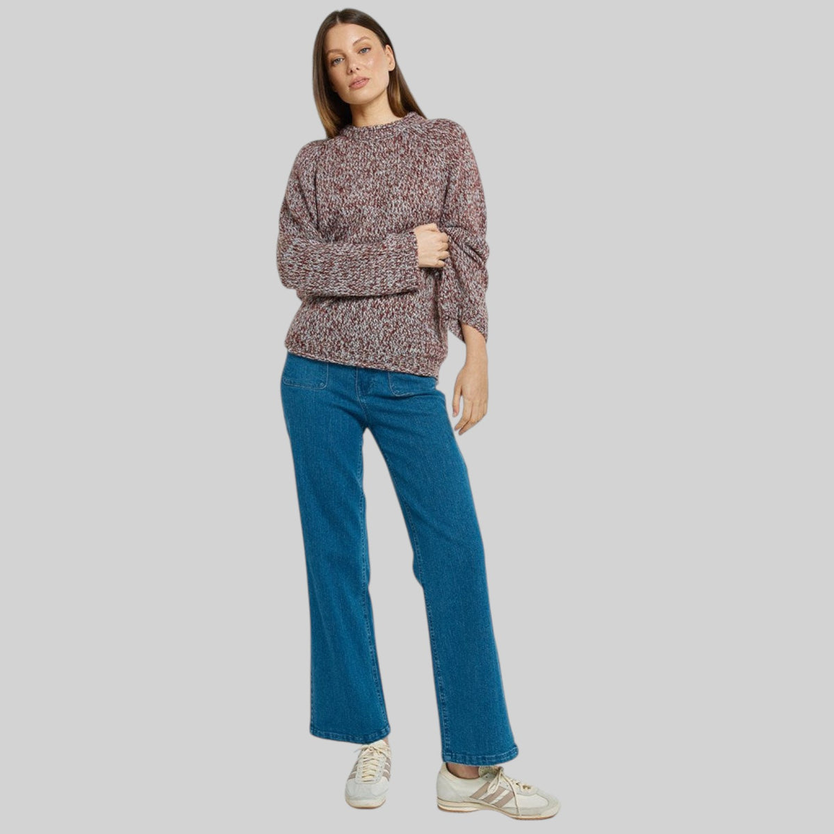 Betty Basics Gracie Multi Red Sweater displayed on a hanger, showcasing its cozy knit fabric and vibrant multi red color.