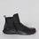 Black NAKED ARCHES Yila boots with sleek design and pointed toes, showcased on a neutral background.