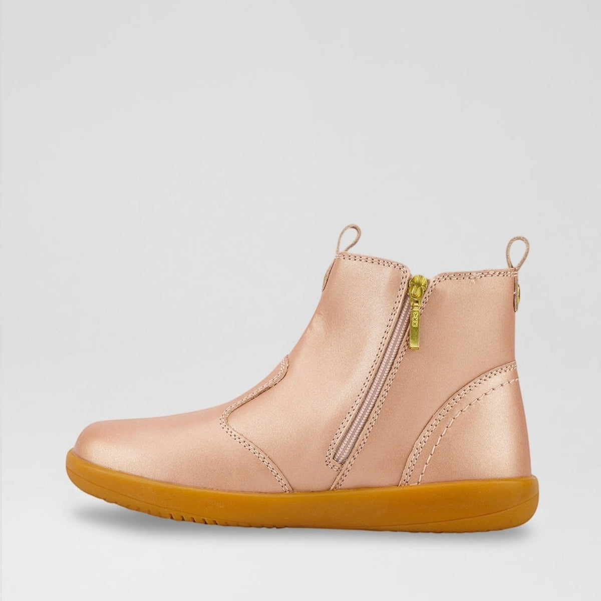 Baby boots by Bobux in Jodhpur Rose Gold color, featuring soft leather and ankle strap for comfortable, stylish baby footwear.