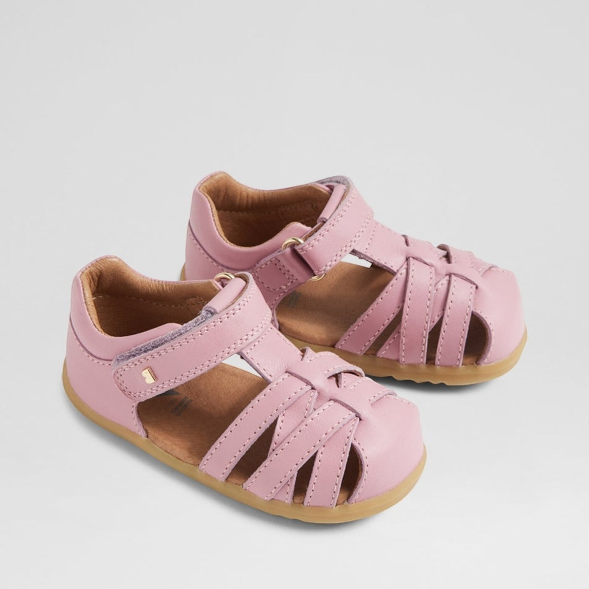Pink Bobux Cross Jump Lilas baby sandals with adjustable straps and soft sole, designed for comfortable little feet.