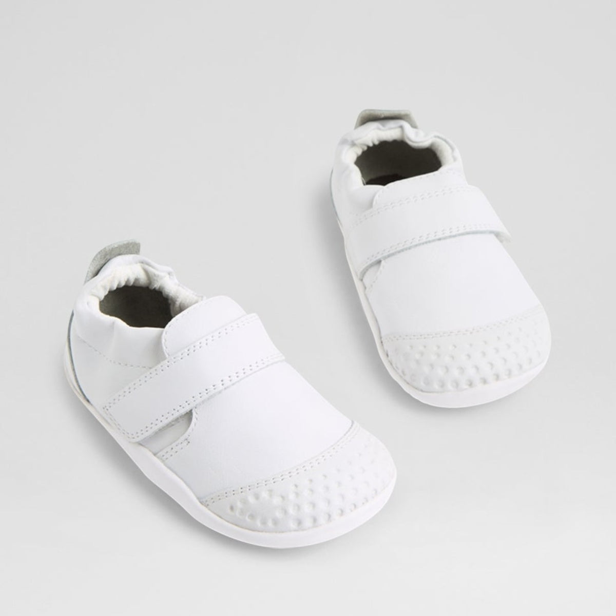 Bobux XP GO white baby sneakers with soft sole and velcro straps, ideal for little feet and early walkers.