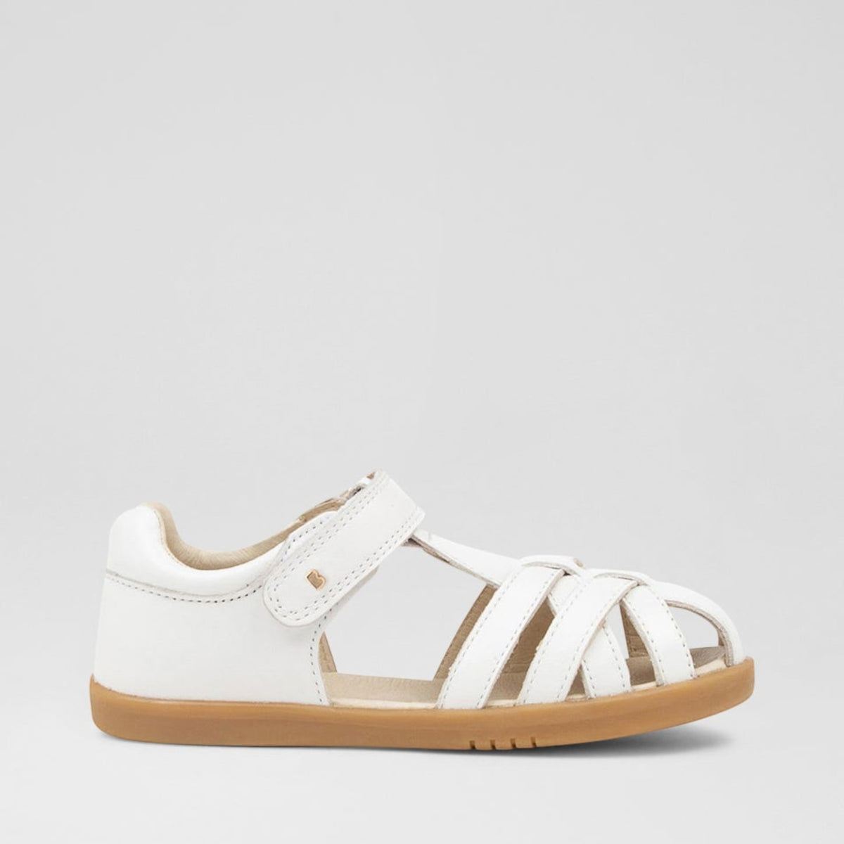 Baby Bobux Cross Jump white sandals with adjustable straps and cushioned soles, designed for comfort and style for little feet.