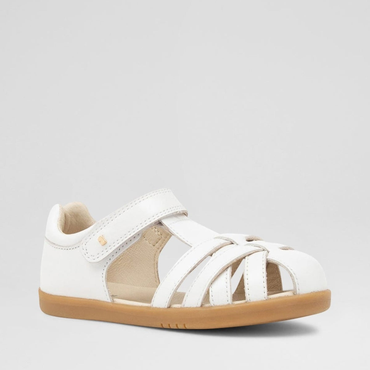 Baby Bobux Cross Jump white sandals with adjustable straps and soft soles, designed for comfort and style for little feet.