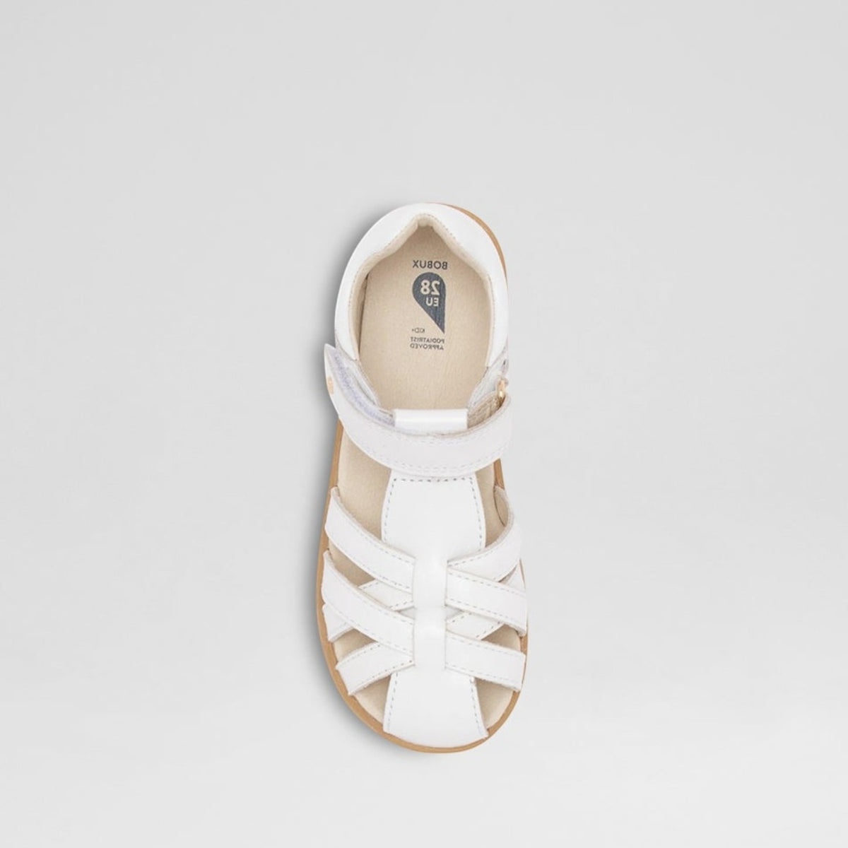 White Bobux Cross Jump baby sandals with adjustable straps and cushioned soles, designed for comfort and support.