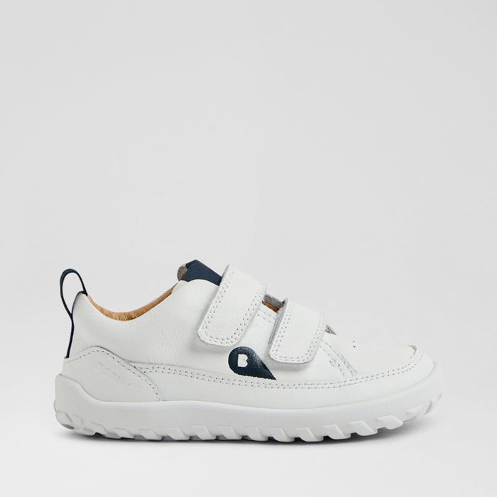 Baby sneakers by Bobux in white and navy with soft soles and Velcro straps, designed for comfortable early walking.