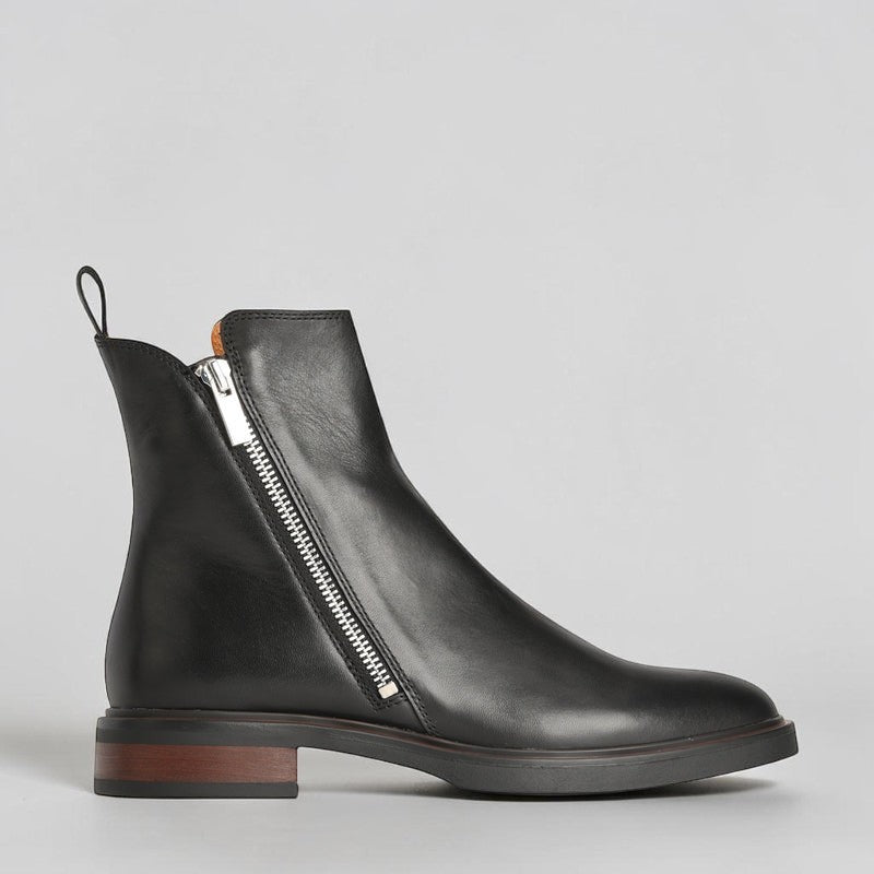 EOS Blaine black boots shown outdoors, featuring sleek leather design and sturdy sole for stylish, versatile footwear.
