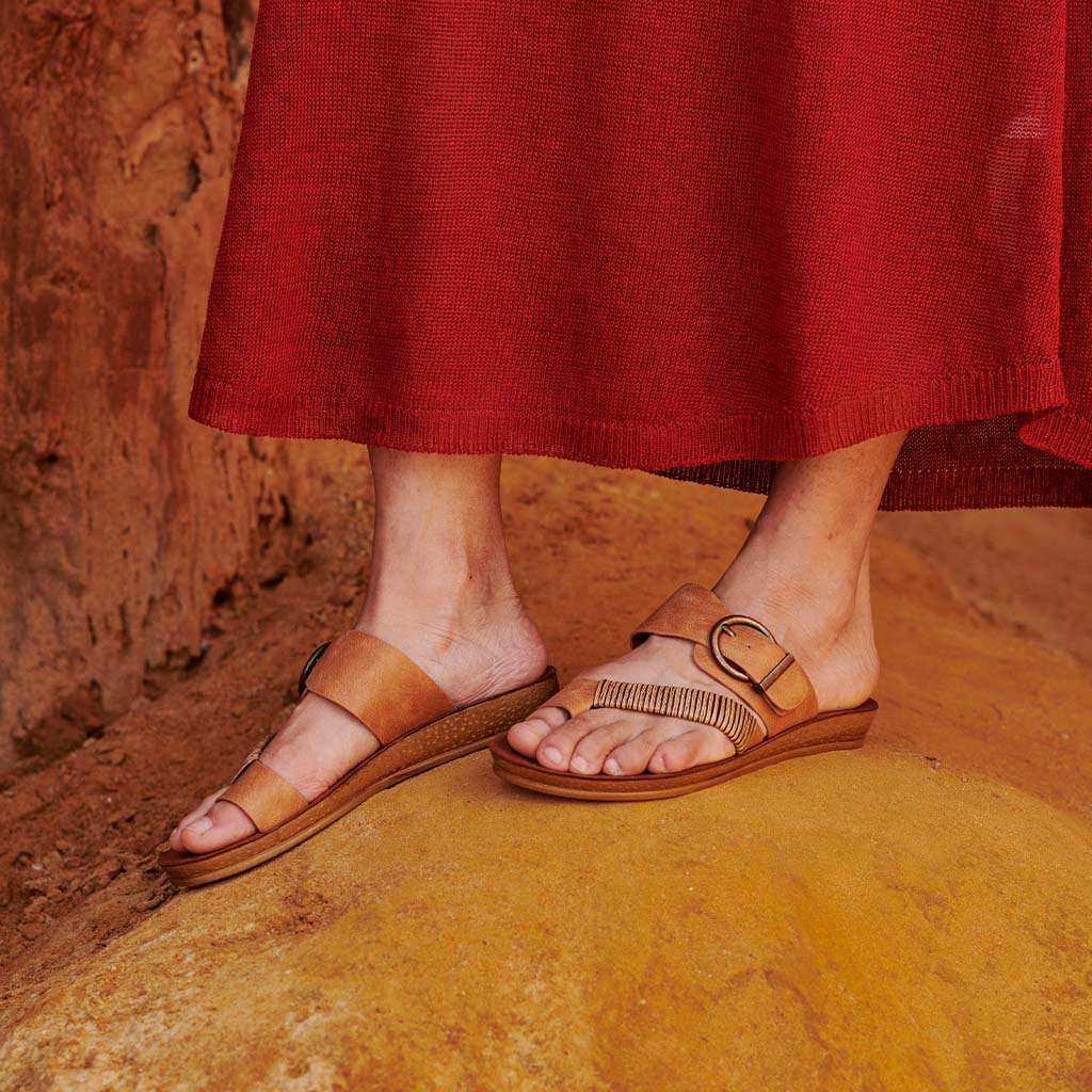 Los Cabos Bria Brand y slip-on shoes in taupe with rounded toes and low heels, showcasing their stylish and comfortable design.