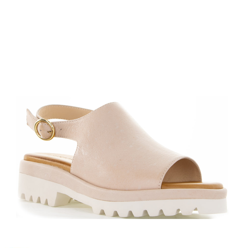 Le Sansa Briar Blush sandals featuring blush pink straps and a comfortable flat sole, perfect for casual summer wear.