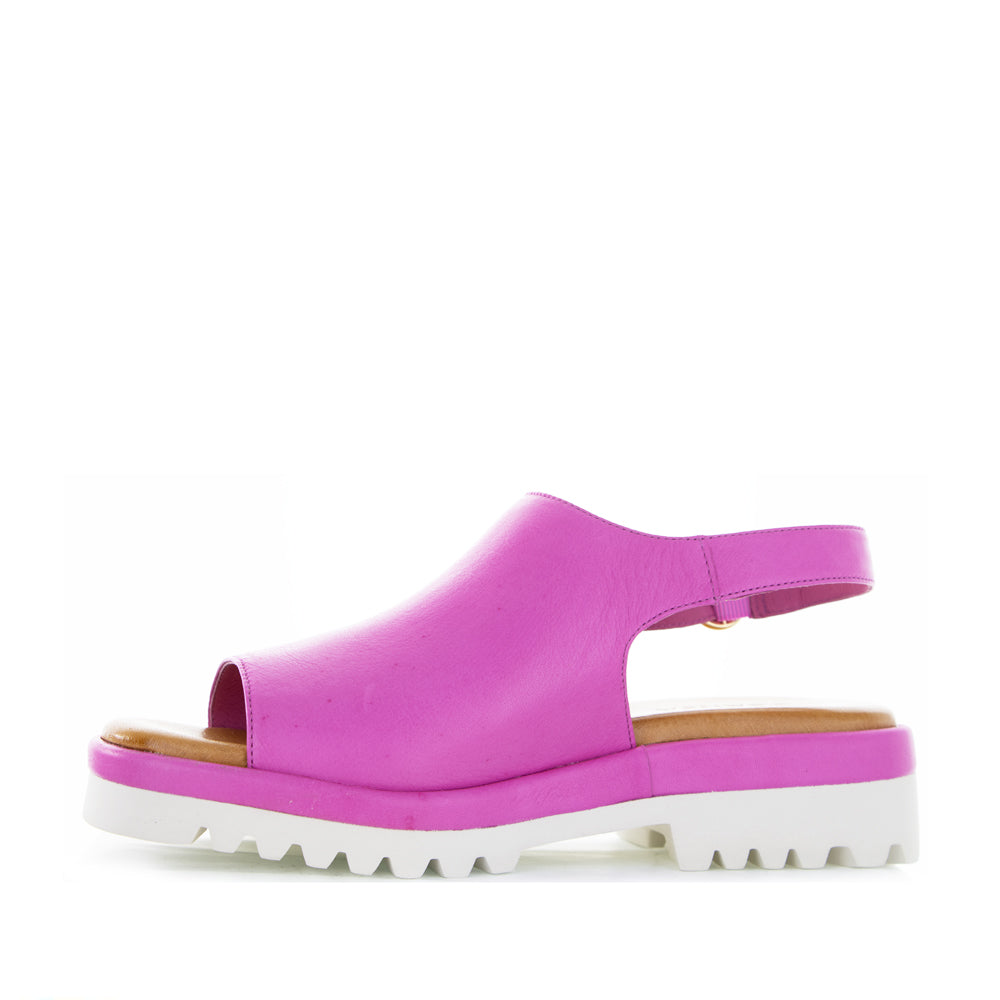 Le Sansa Briar Hot Pink sandals featuring stylish straps and a comfortable flat sole, perfect for casual summer wear.