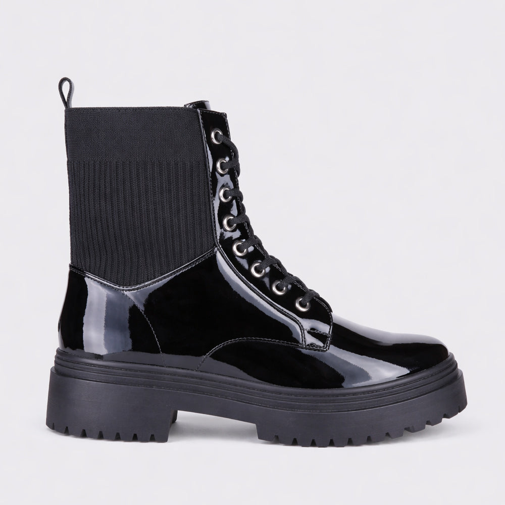 LE SANSA Candy black patent boots with sleek shiny finish and pointed toe design, stylish footwear for modern outfits.
